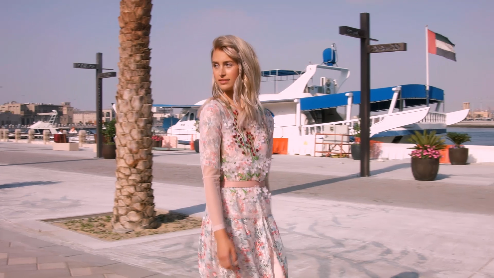 Model in front of boat in Dubai